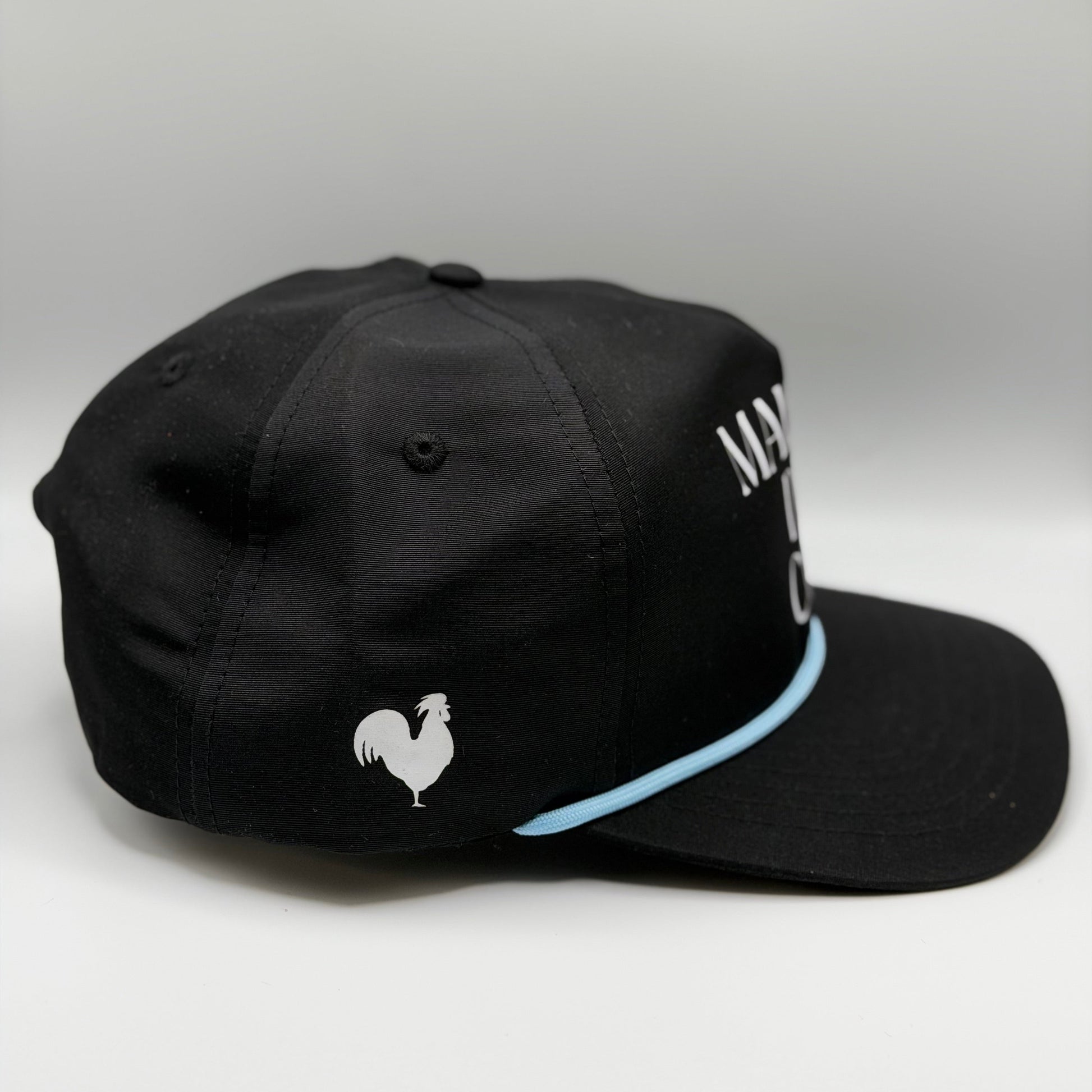 A side profie of a black hat with a blue rope and a rooster logo on the side